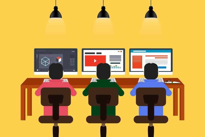 Three people on computers at desk cartoon